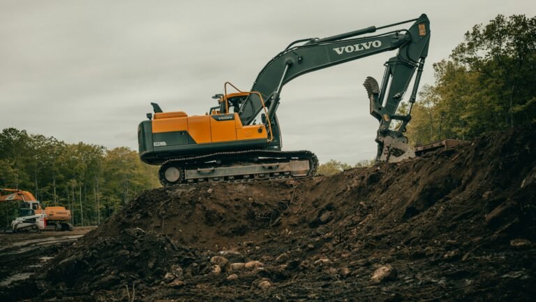 Tracked excavator working on top of a spoil heap during groundworks