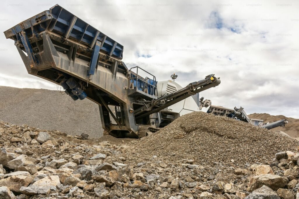 Mobile tracked crusher processing stone rubble into recycled aggregate