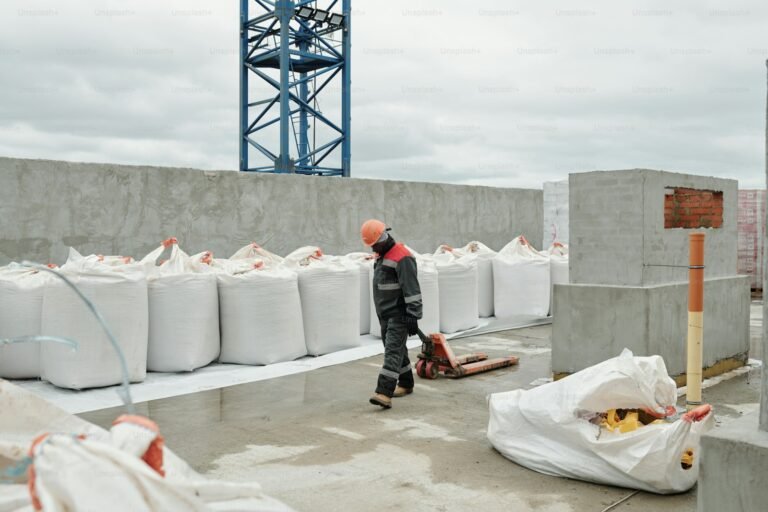 Rows of white bulk bags of building materials on a construction site