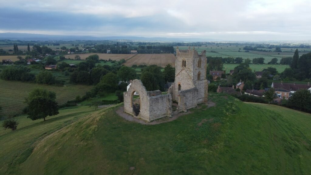 Aerial view of Burrow Mump church ruin above the flat Somerset Levels near Bridgwater