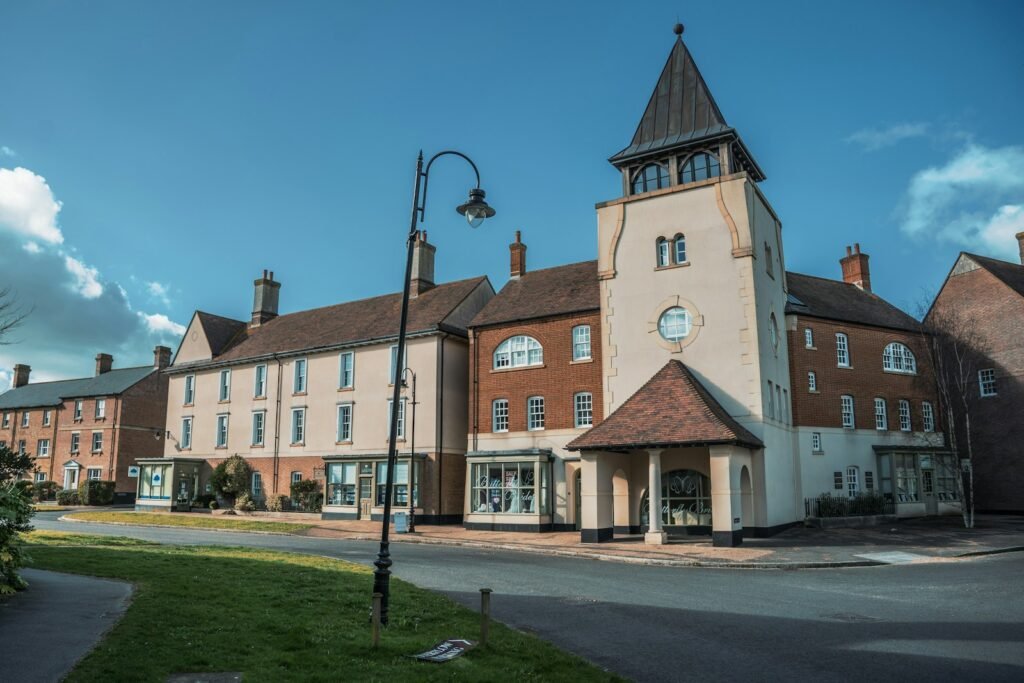 Brick and render buildings with a clock tower in Poundbury on the edge of Dorchester